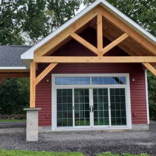Front view of 18 x 30 Timber Frame pool house, Stone face to be installed on concrete pillars