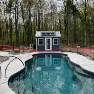 10 x 12 Smartside shed-row dormer cottage with metal roof and 15 lite front door